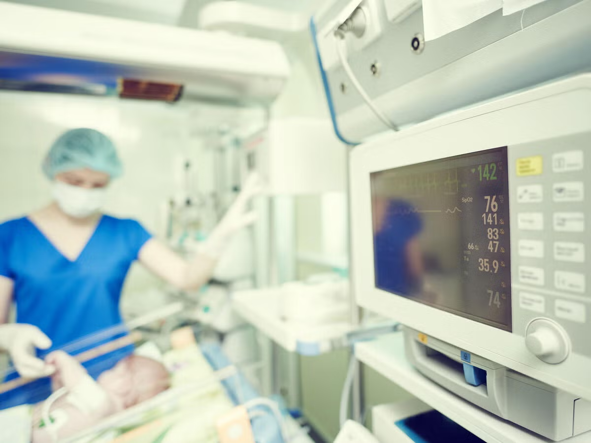 Medical staff operating equipment in an operating room